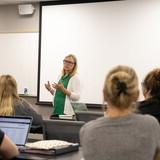 Social Work Program Director Toni Jensen in the front of a classroom teaching.